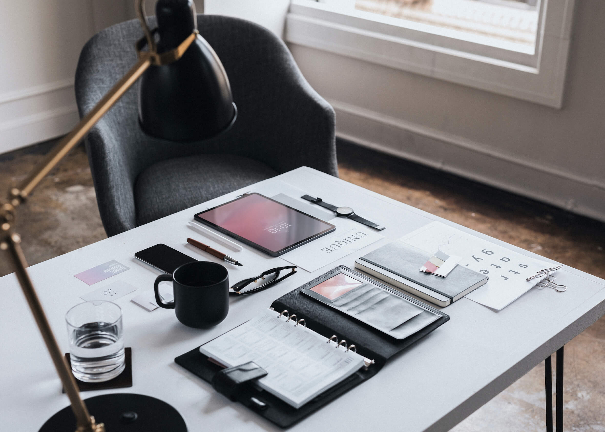 Planner on a desk with digital devices